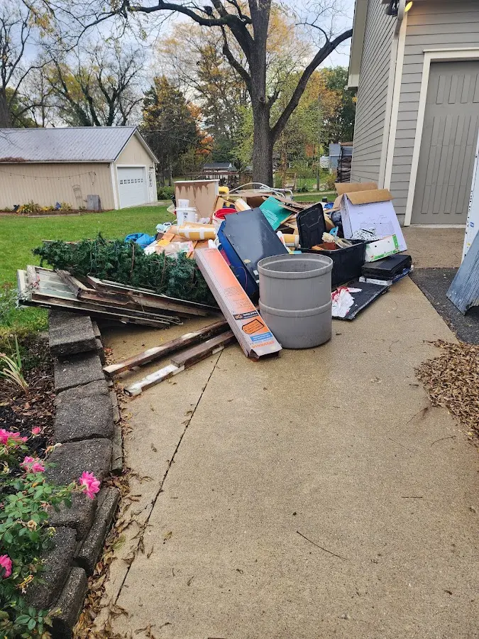 Dumpster being loaded with debris for Estate Cleanout Dumpster Rental in Winston-Salem